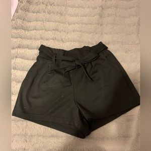 Black paper bag shorts with belt and 2 front pockets.
